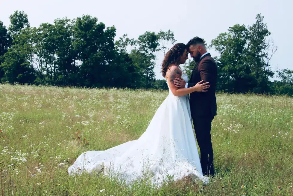 A bride and groom embracing in the wildflower meadow at Rockin' T Ranch